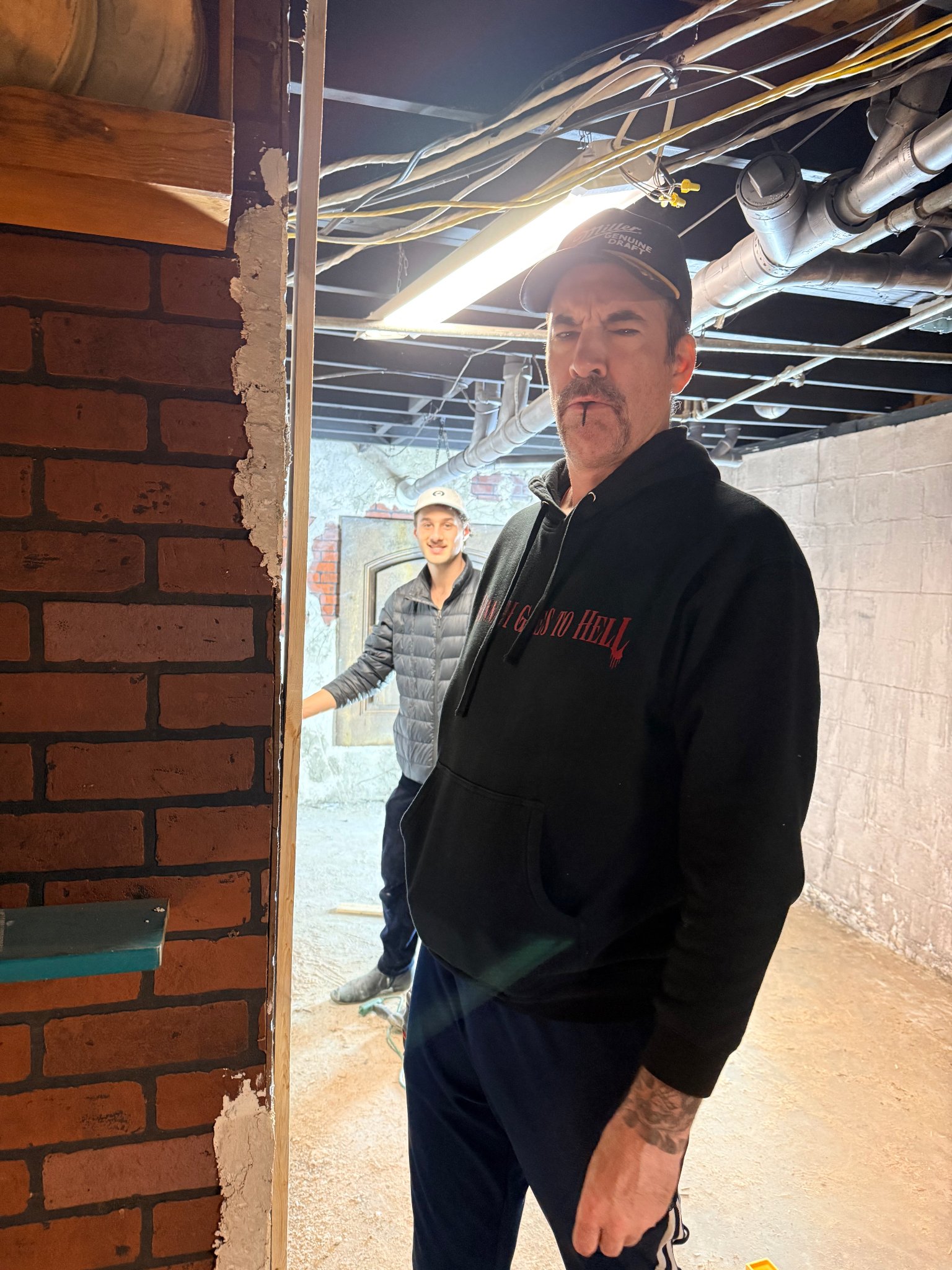 Behind the scenes — actor in Hannah Goes to Hell hoodie on set