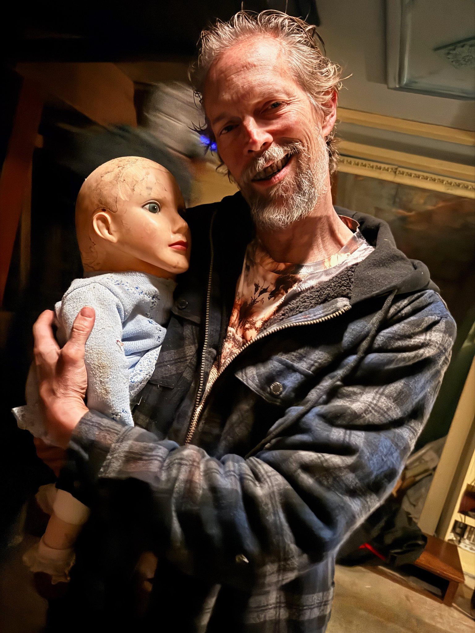 Behind the scenes — actor with creepy doll prop, Hannah Goes to Hell